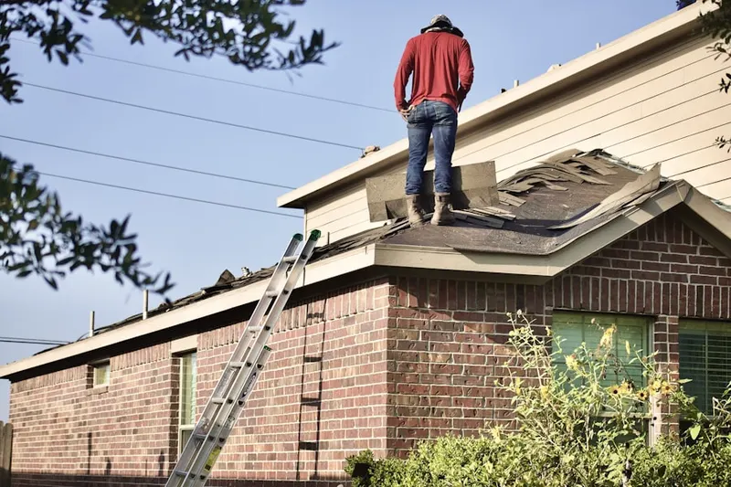 Professional roofer working on a residential roof in East Bradford